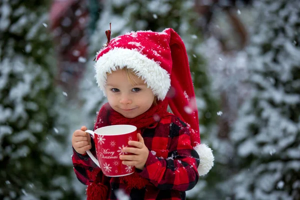 甜美美丽的幼儿男孩 拿着热牛奶杯 在外面雪地里喝水 享受寒假和圣诞假期 — 图库照片