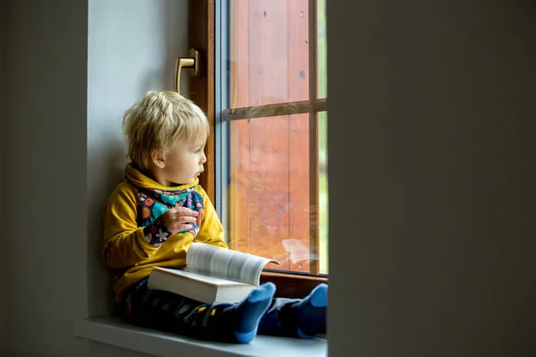Cute Toddler Child Blond Boy Sitting Window Home Reading Book — Stock Photo, Image