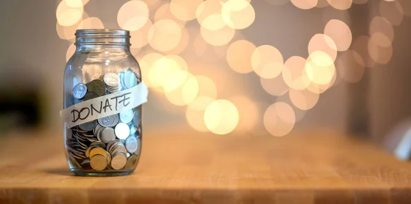 Jar full of coins for donation — Stock Photo, Image