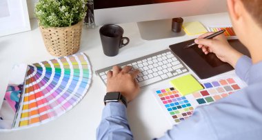Tablet ve renk swatches çizim ile çalışan grafik tasarımcı