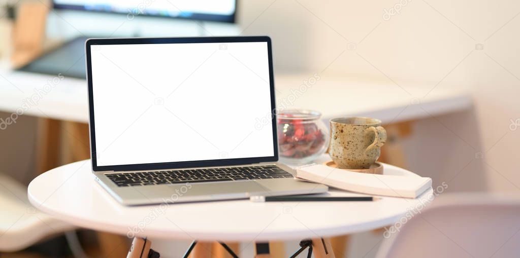 Blank screen laptop in minimal workspace