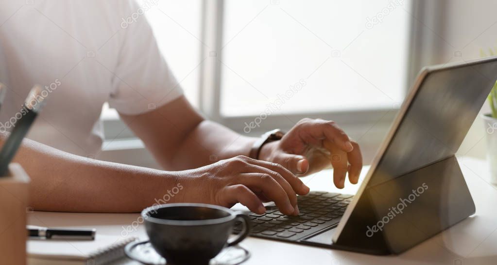 Young man typing on keyboard laptop 