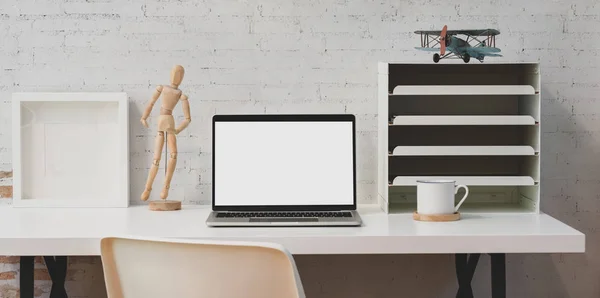 Simple white workplace with open blank screen laptop