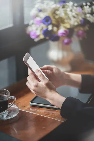 Young businesswoman holding blank screen smartphone