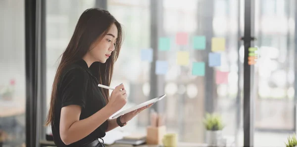 Hermosa freelancer femenina recogiendo la idea de la nota adhesiva —  Fotos de Stock