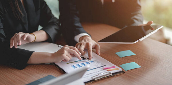 Close-up view of business partner discussing the project togethe