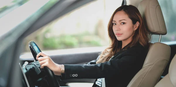 Profesional mujer de negocios mirando a la cámara mientras conduce t — Foto de Stock