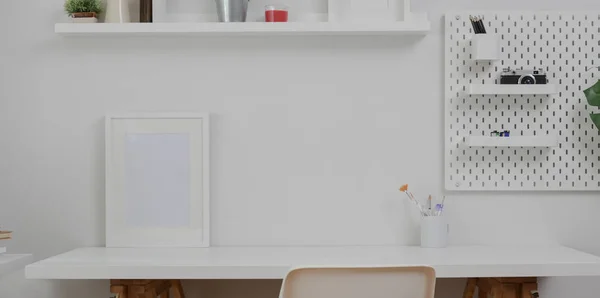 Minimal white workplace with mock up frame  and office supplies