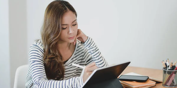 Professional young designer editing her project on tablet