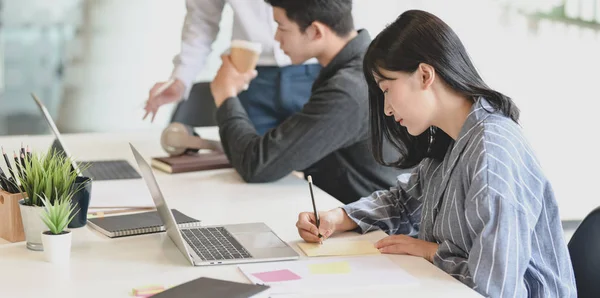 Jungunternehmerin arbeitet mit ihren Teammitgliedern an ihrem Projekt — Stockfoto