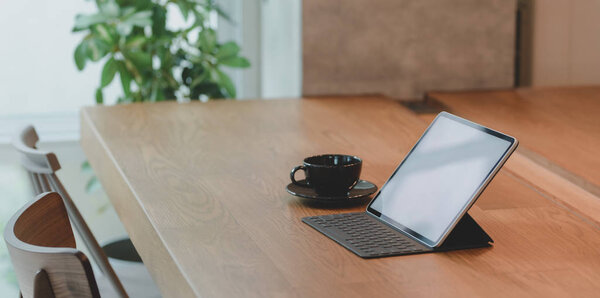 Чистый экран планшета и чашку кофе в удобном рабочем месте с расслабляющей атмосферой
 