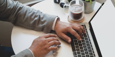 Projesi üzerinde çalışırken dizüstü bilgisayarla çalışan işadamının yakın görüntüsü 