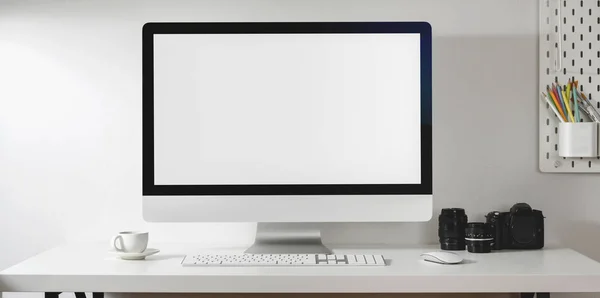 Mock up desktop computer with camera and office supplies in modern office style on white desk