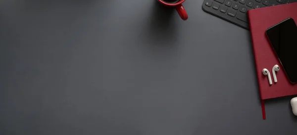 Overhead shot of dark luxury workspace with red notebook and copy space με προμήθειες γραφείου σε γκρι φόντο — Φωτογραφία Αρχείου