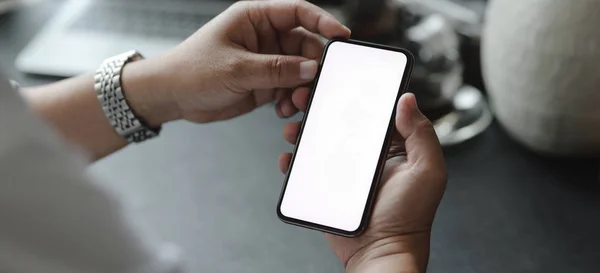 Cropped shot of businessman looking at his mock up smartphone — Stock Photo, Image