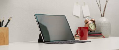 Kırtasiye ve dekorasyonlarla modern çalışma tabletinde klavye ile kırpılmış dijital tablet görüntüsü