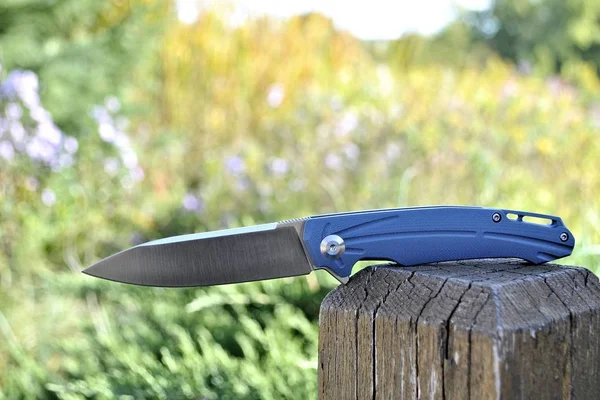 Modern pocket folding knife stainless steel blade green outdoor nature garden colors