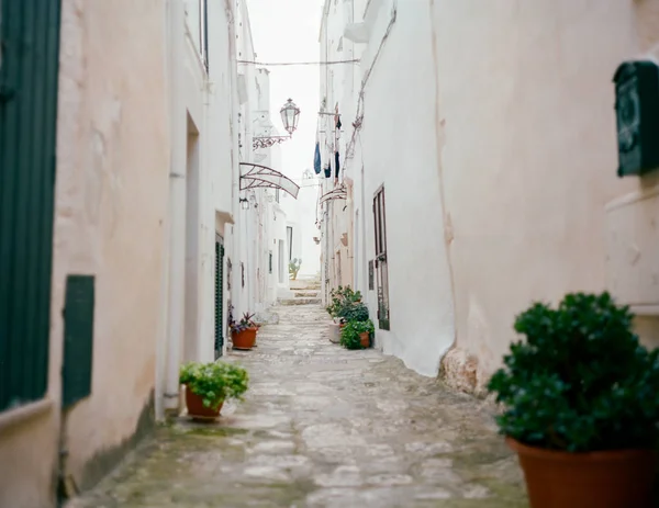 View of narrow walkway whit white houses, Mediterranean city