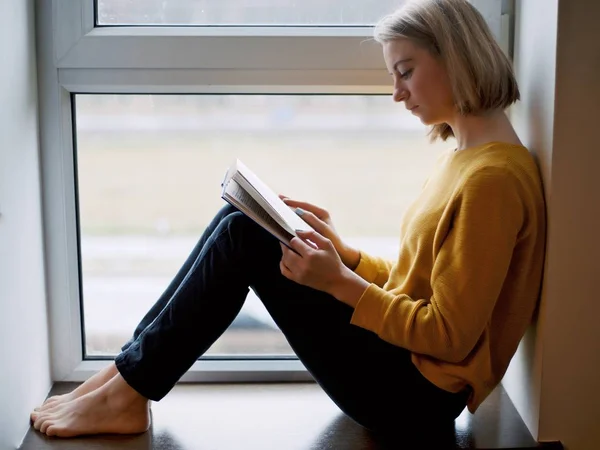 Woman leafing through and studying dictionaries