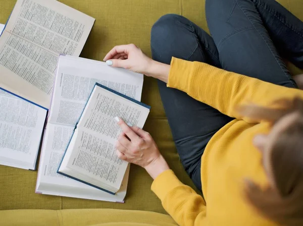 Woman leafing through and studying dictionaries