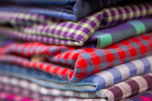 View of the folded shirts stacked over one another after ironed.