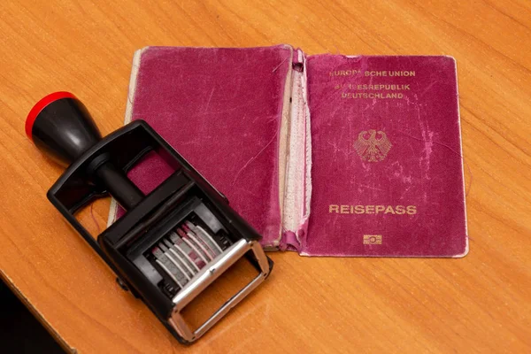 A shabby, sloppy biometric passport with date stamper. Irrespons — Stock Photo, Image
