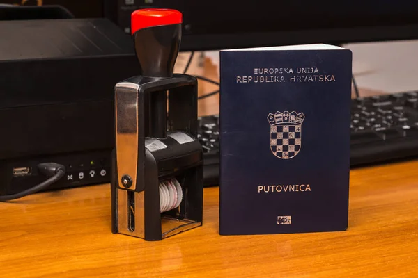 Close-up of a Croatian biometric passport with a border date sta