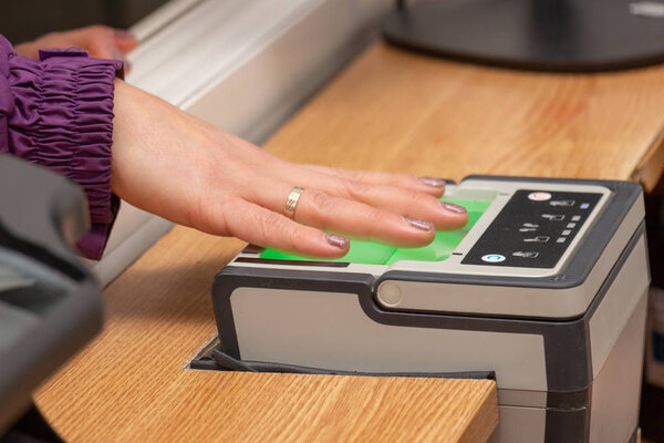 The process of scanning fingerprints during the check at border 