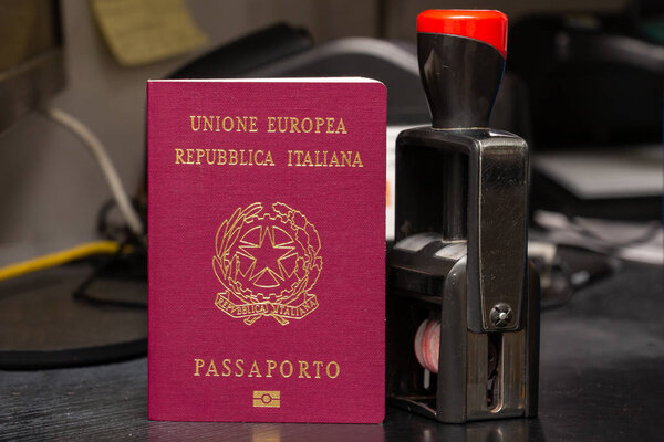Red biometric passport of a Italian citizen with a border date s