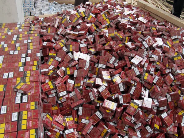 Smuggled cigarettes disguised as industrial wood  were found by — Stock Photo, Image