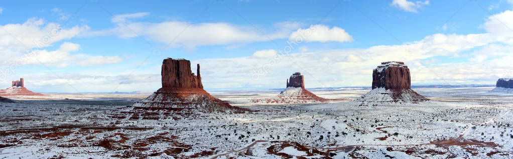 Panoramic view of the Monument Valley in Arizona covered in snow on a sunny winter day
