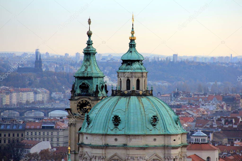 Panoramic view of Prague with the Dome of St. Nicolas church on a foreground