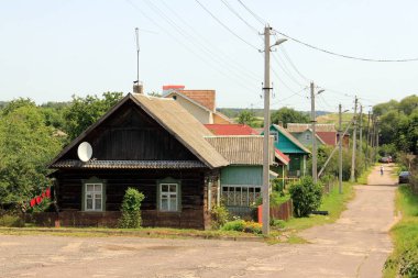 Village street with a wooden house, Zaslawye, Belarus