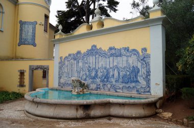 Revivalist-style Palace of the Counts of Castro Guimaraes, built in 1900, currently a museum, ornate water fountain adorned with azulejos at the entrance, Cascais, Portugal - December 26, 2017 clipart