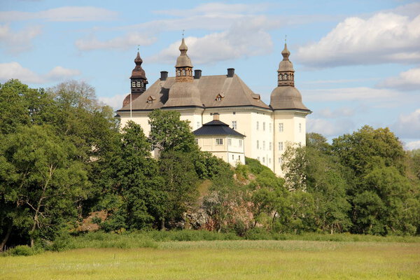 17th-century white Ekenas Castle in the rural landscape, Linkoping Municipality, Sweden - July 10, 2019