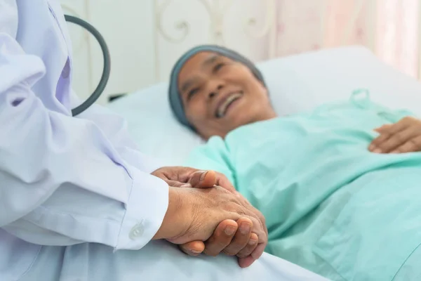 selective focused of doctor's hands hold patient's hands to give