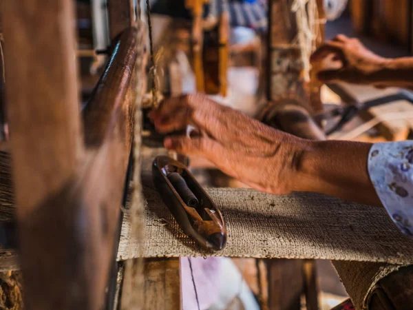 The local Intha woman weaving the lotus cloth with the hand loom