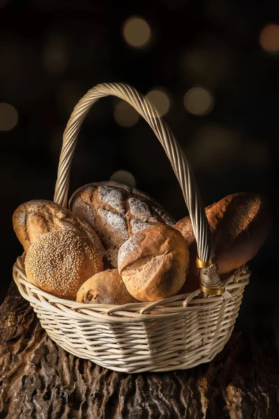 food background of a basket with assortment of bread on wooden p