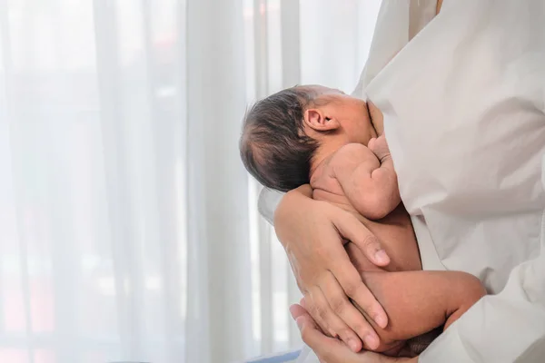 Mother in white shirt having breast  feeding to her baby boy — Stok fotoğraf