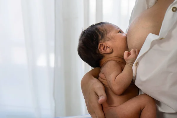 Mother having breast feeding to her infant baby boy — Stok fotoğraf