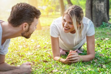 couple exercising and workout together in park