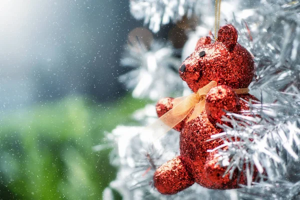 Close up of Christmas ornaments bear hanging on silver Christmas — Stock Photo, Image