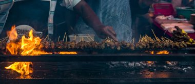 The blurred image of roasting meat, chicken and mutton Satays at