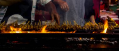 The blurred image of roasting meat, chicken and mutton Satays at