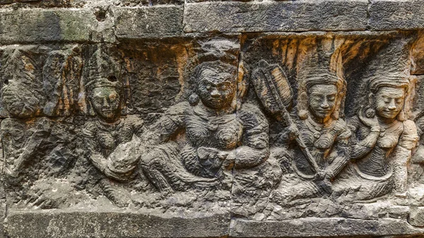 The art of high relief carving on the stone at the Angkor in Siem Reap, Cambodia. The carving telling story of the god of death.