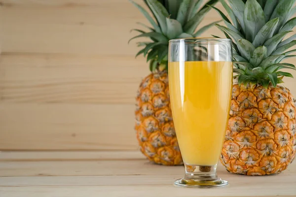 Fruta fresca natural y jugo de piña sobre fondo de madera — Foto de Stock