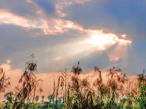 Solnedgången bakom molnet med gyllene solljus under solnedgången — Stockfoto