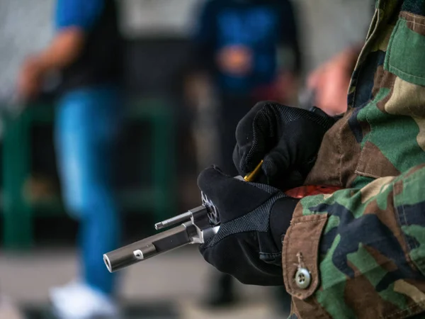 Revolver hand gun in hands with black gloves filling up bullets