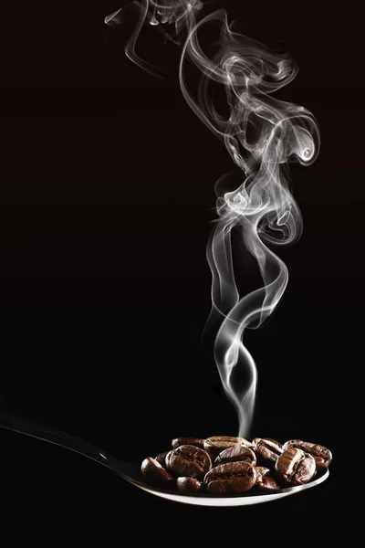 На фоне напитков жареных кофейных зерен в ложке изолированы на — стоковое фото