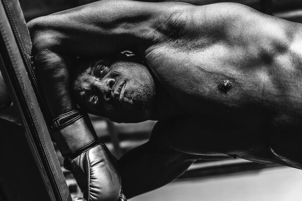 close up portrait of african american boxer face with serious eyes looking in black and white